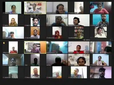 A digital display features several people, indicating a virtual gathering or collaborative session.