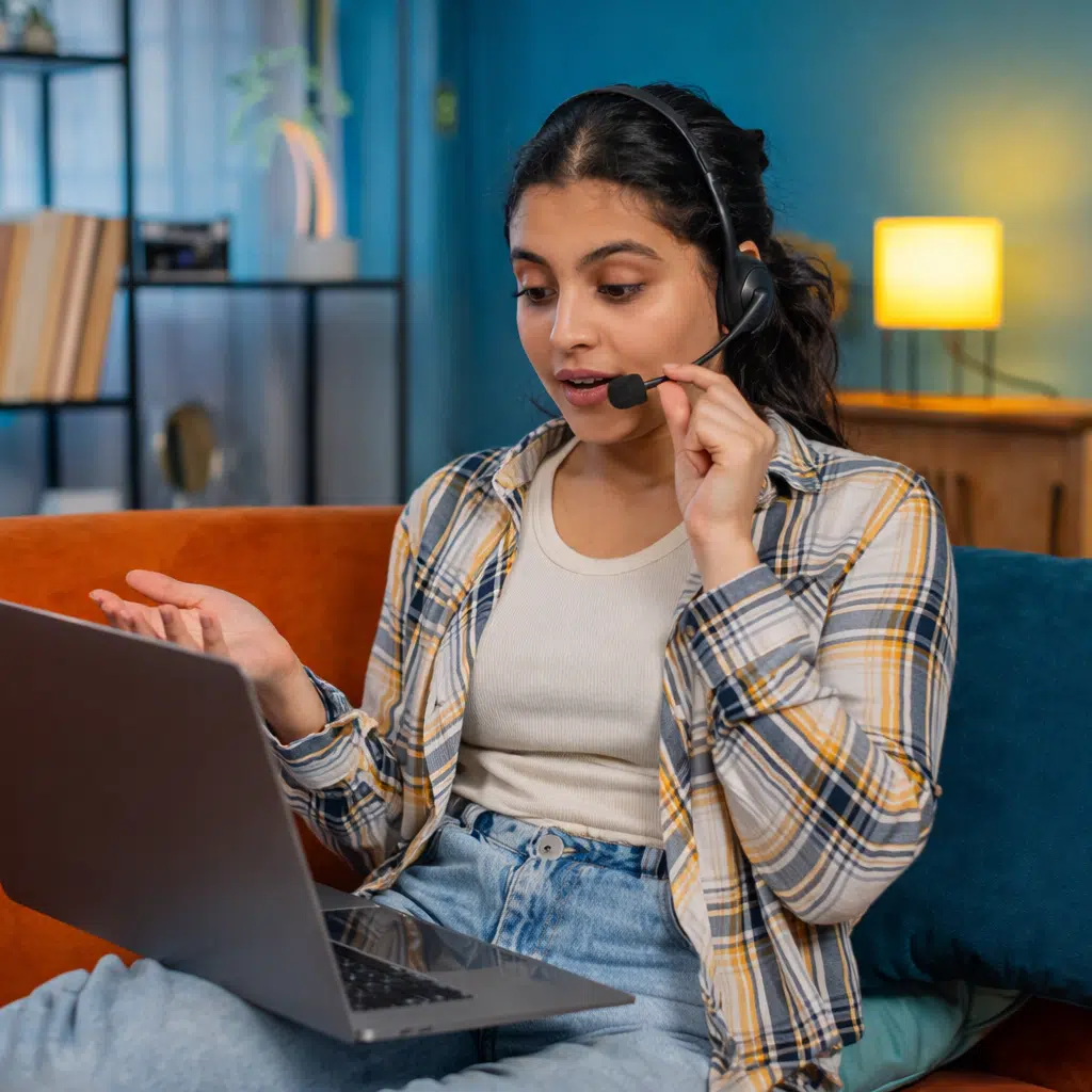 Beginner attending online English speaking class using headset and laptop