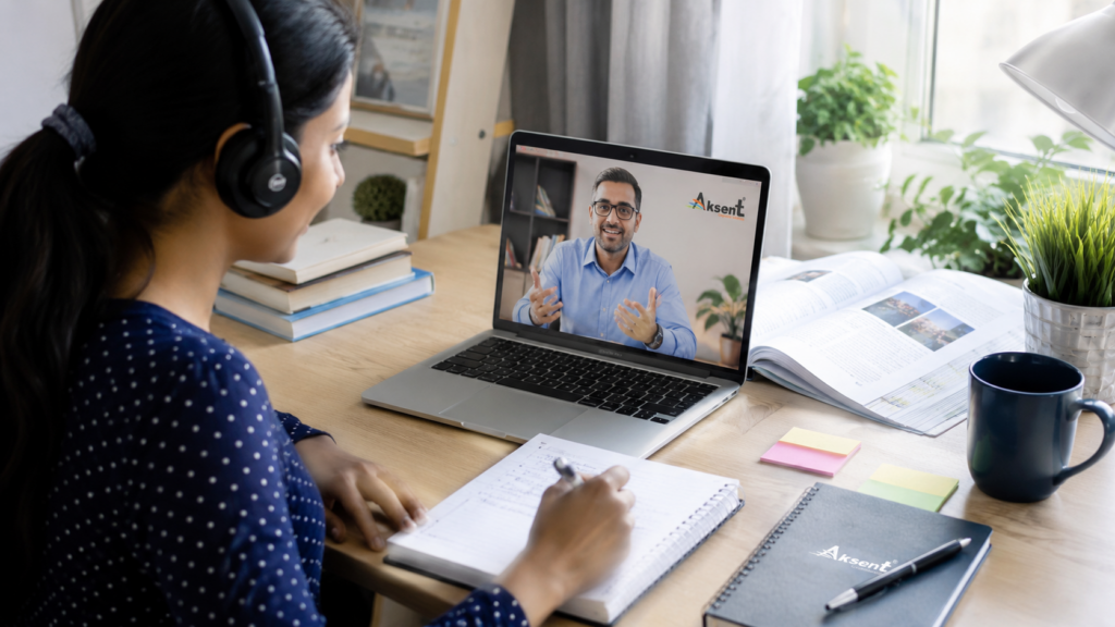 Student attending Aksent online English class with modules for listening, speaking, reading, and writing
